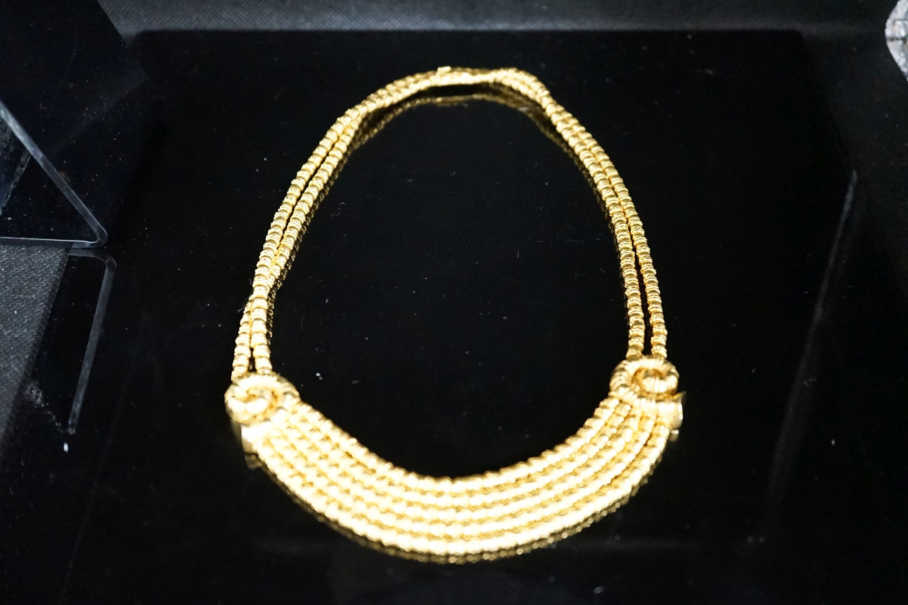 Ilias Lalaounis: a 750 yellow metal multi strand necklace, with shell motifs, 40cm, 146.3 grams, signed.